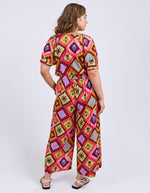 Woman wearing a colorful patterned dress on a white background
Rhode Pants Geo Print