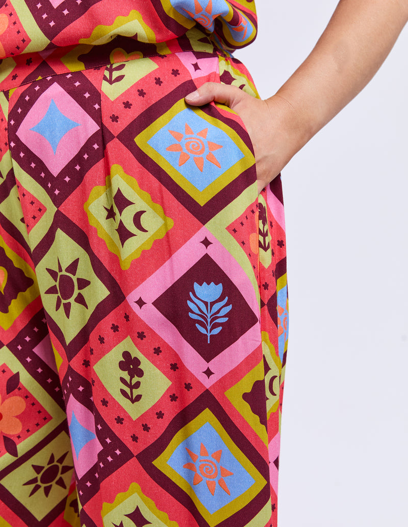 Colorful patterned fabric with geometric designs on a plain background
Rhode Pants Geo Print