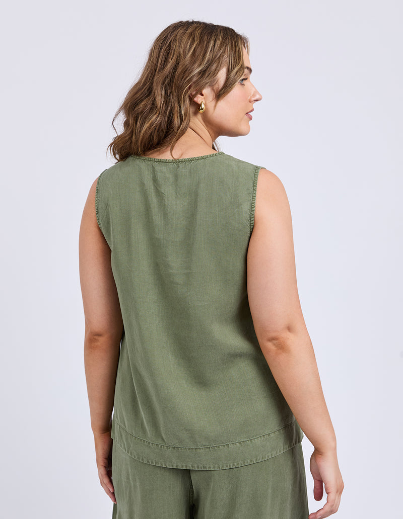 Woman wearing a green sleeveless top and pants on a light gray background
Bliss Tank Clover