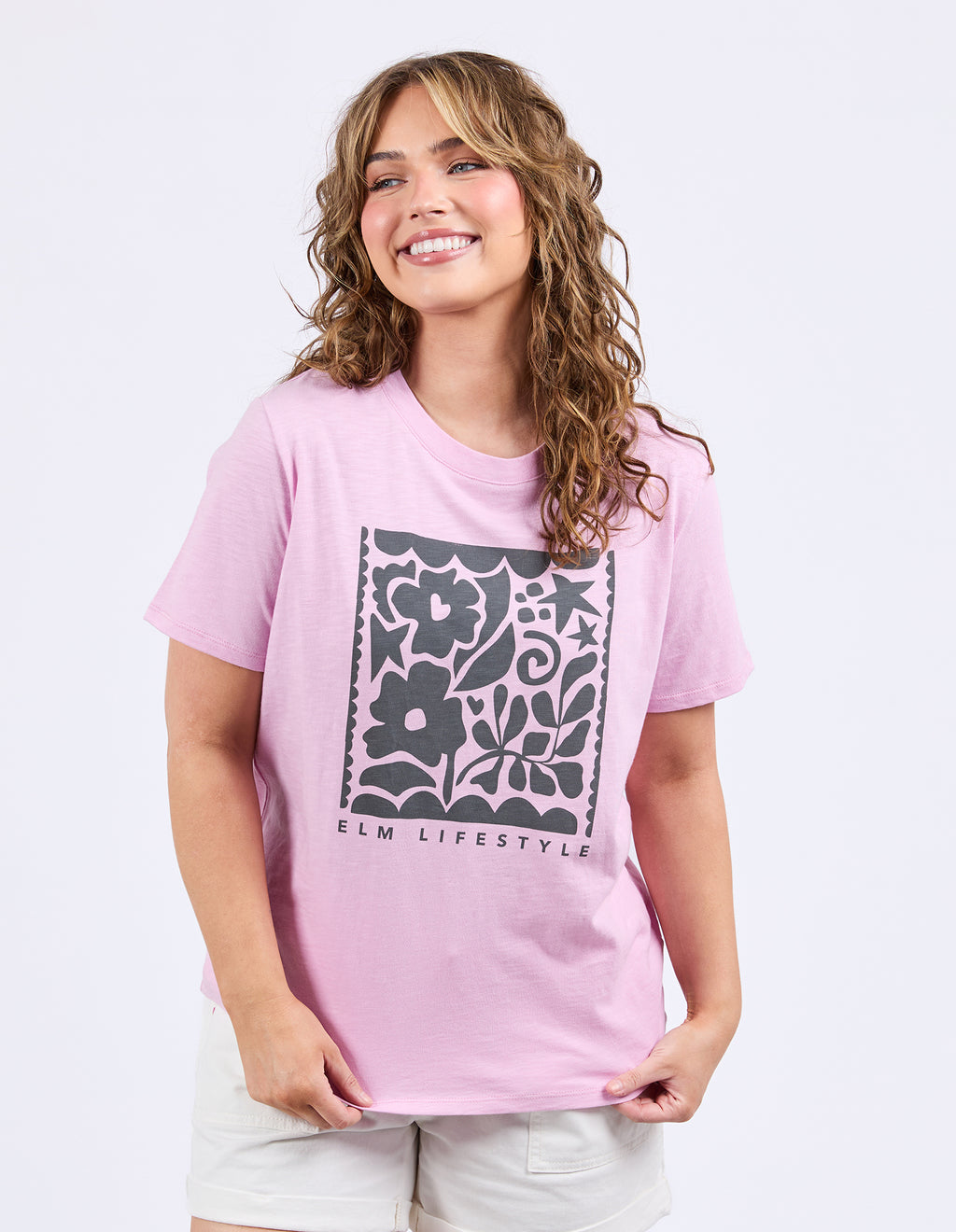 Woman wearing a pink t-shirt with floral design and 'ELM Lifestyle' text on a white background
Winona Tee Dusk Pink