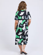 Woman wearing a patterned dress with abstract shapes on a white background
Stijl Dress Charcoal