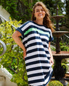 Woman wearing a navy and white striped dress with green accents in an outdoor setting.
McKinley Dress Navy