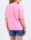 Person wearing a pink t-shirt and blue shorts on a light purple background
Camelia Tee Chateau Rose