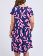 Navy dress with pink leaf pattern worn by a person on a white background
Mimosa Dress Blue Depths