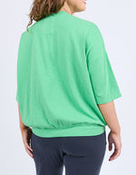 Person wearing a green shirt and dark pants on a white background
Mazie Sweat Spring Green