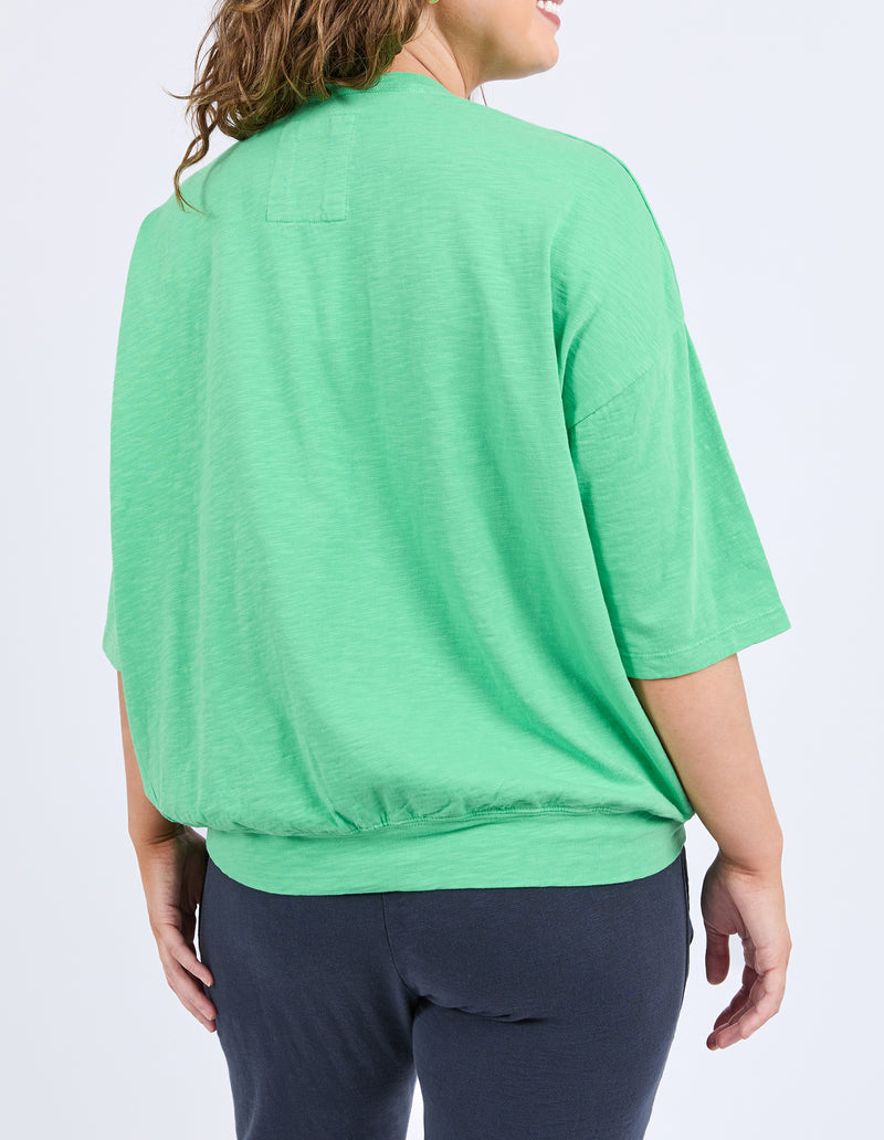 Person wearing a green shirt and dark pants on a white background
Mazie Sweat Spring Green