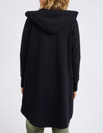 Black hooded coat worn by a person on a white background
Mara Zip Hoodie Black