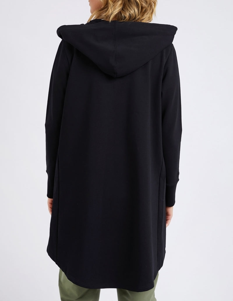 Black hooded coat worn by a person on a white background
Mara Zip Hoodie Black