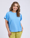 Woman wearing a blue t-shirt and green pants on a light gray background
Shelby Tee Azure Blue