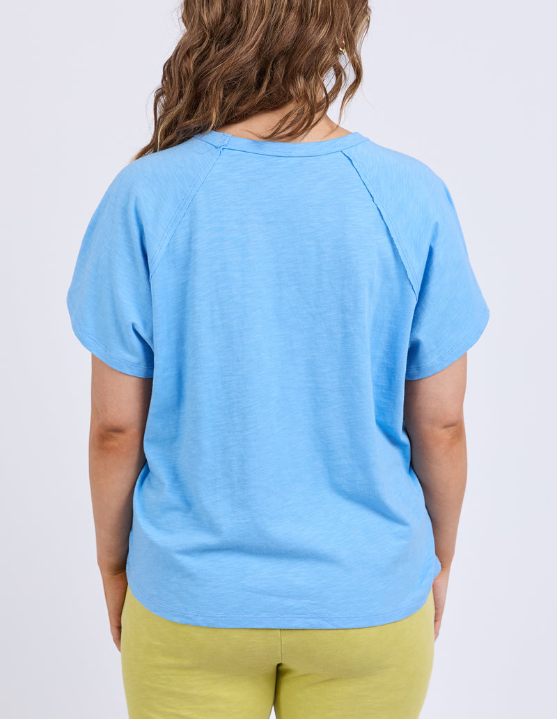 Person wearing a light blue t-shirt and green pants on a white background
Shelby Tee Azure Blue