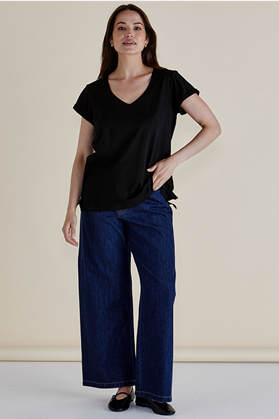 Woman wearing a black top and blue jeans against a beige background
Ayla V-Neck Tee Black
