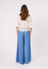 Woman wearing a white lace top and blue wide-leg pants on a white background
Azzura Pant Chambray