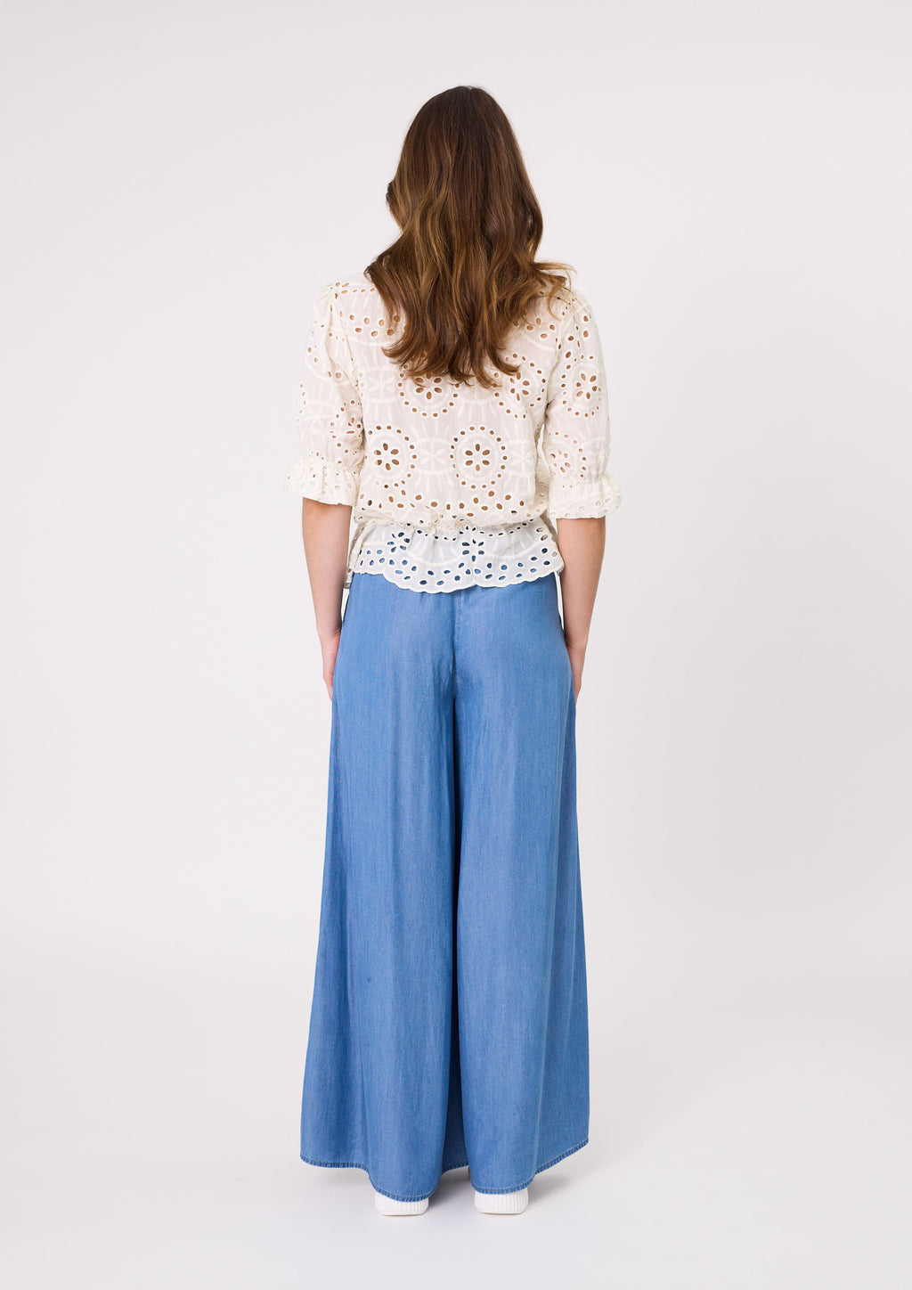 Woman wearing a white lace top and blue wide-leg pants on a white background
Azzura Pant Chambray