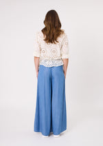 Woman wearing a white lace top and blue wide-leg pants on a white background
Azzura Pant Chambray