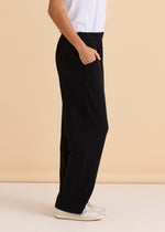 Person wearing black wide-leg pants and a white top against a beige 
Ginnie Bamboo Pant Blackbackground