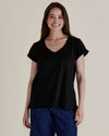 Woman wearing a black top and blue pants against a beige background
Ayla V-Neck Tee Black