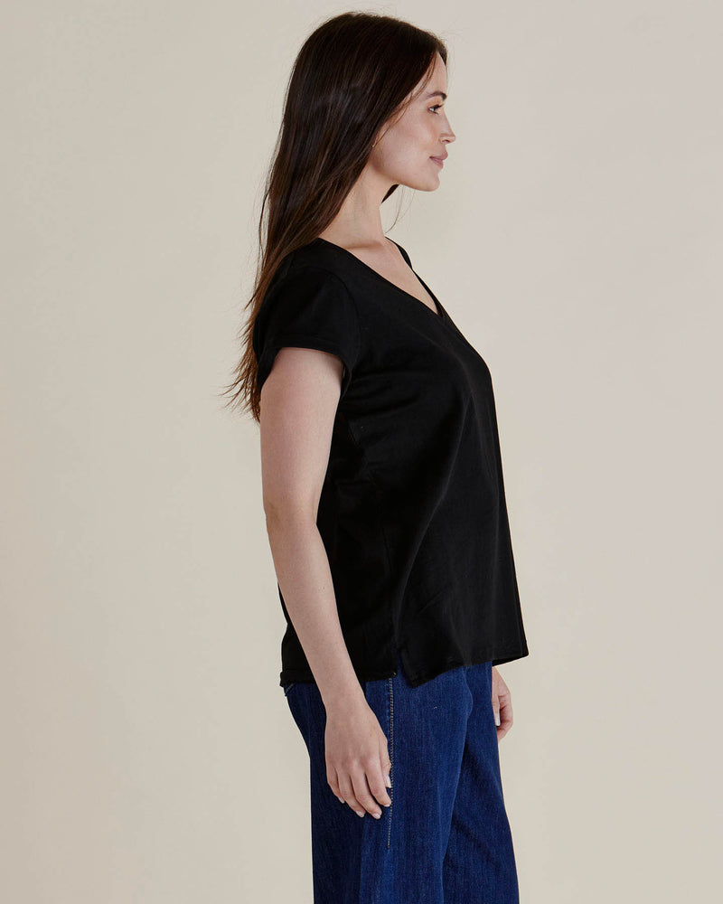 Woman wearing a black top and blue pants against a plain background
Ayla V-Neck Tee Black