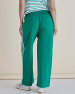 Person wearing green pants with white stripes and a striped shirt on a beige background
Nikki Relax Cotton Jogger Green