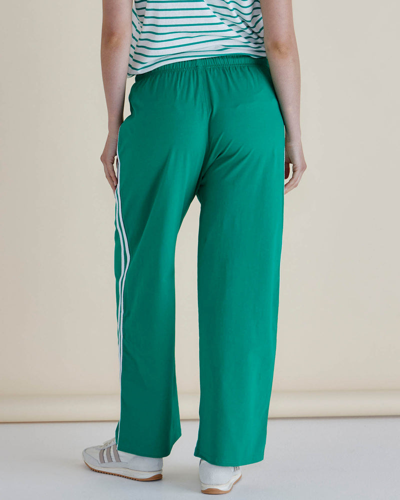 Person wearing green pants with white stripes and a striped shirt on a beige background
Nikki Relax Cotton Jogger Green