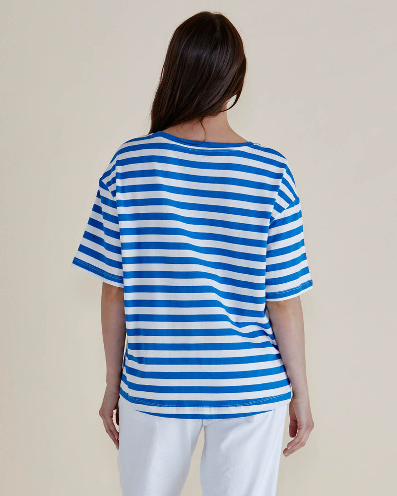 Person wearing a blue and white striped shirt against a plain background