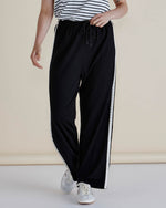 Person wearing black pants with a white stripe on a plain background
Evelyn Wide Leg Jogger Black