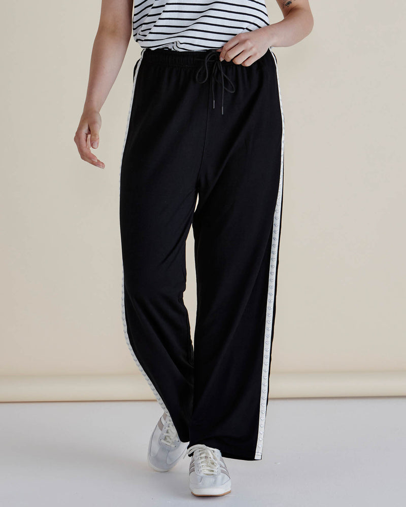 Person wearing black pants with a white stripe on a plain background
Evelyn Wide Leg Jogger Black