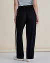 Person wearing black pants with a white stripe on a beige background
Evelyn Wide Leg Jogger Black