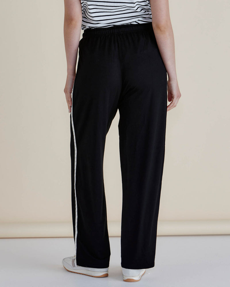 Person wearing black pants with a white stripe on a beige background
Evelyn Wide Leg Jogger Black