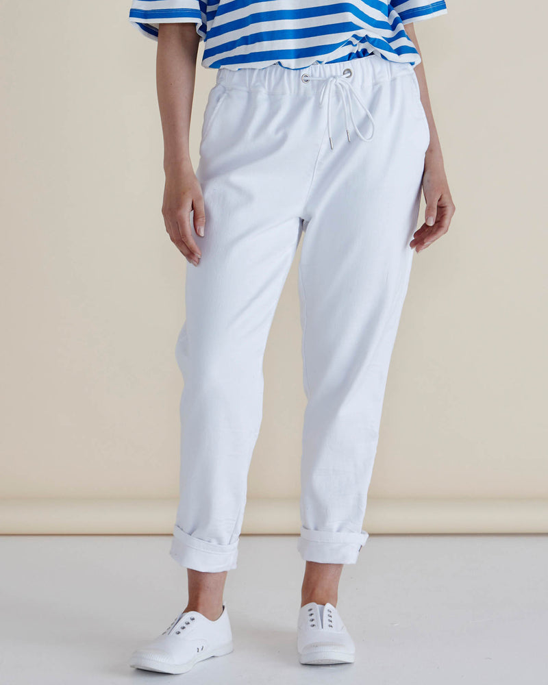Person wearing a blue and white striped shirt with white pants on a beige background
Brooks Jean Snow White