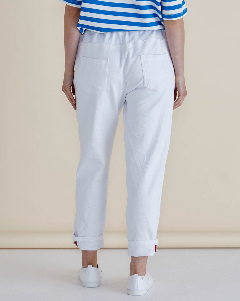 Person wearing light gray pants and a blue and white striped shirt on a beige background
Brooks Jean Snow White