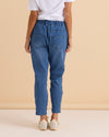 Person wearing blue jeans and a white shirt against a beige background
Brooks Jean True Blue