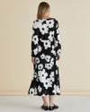 Woman wearing a black floral dress against a beige background
Aries Dress Floral