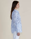 Woman wearing a light blue floral blouse against a plain background
Lace Stripe Shirt Blue