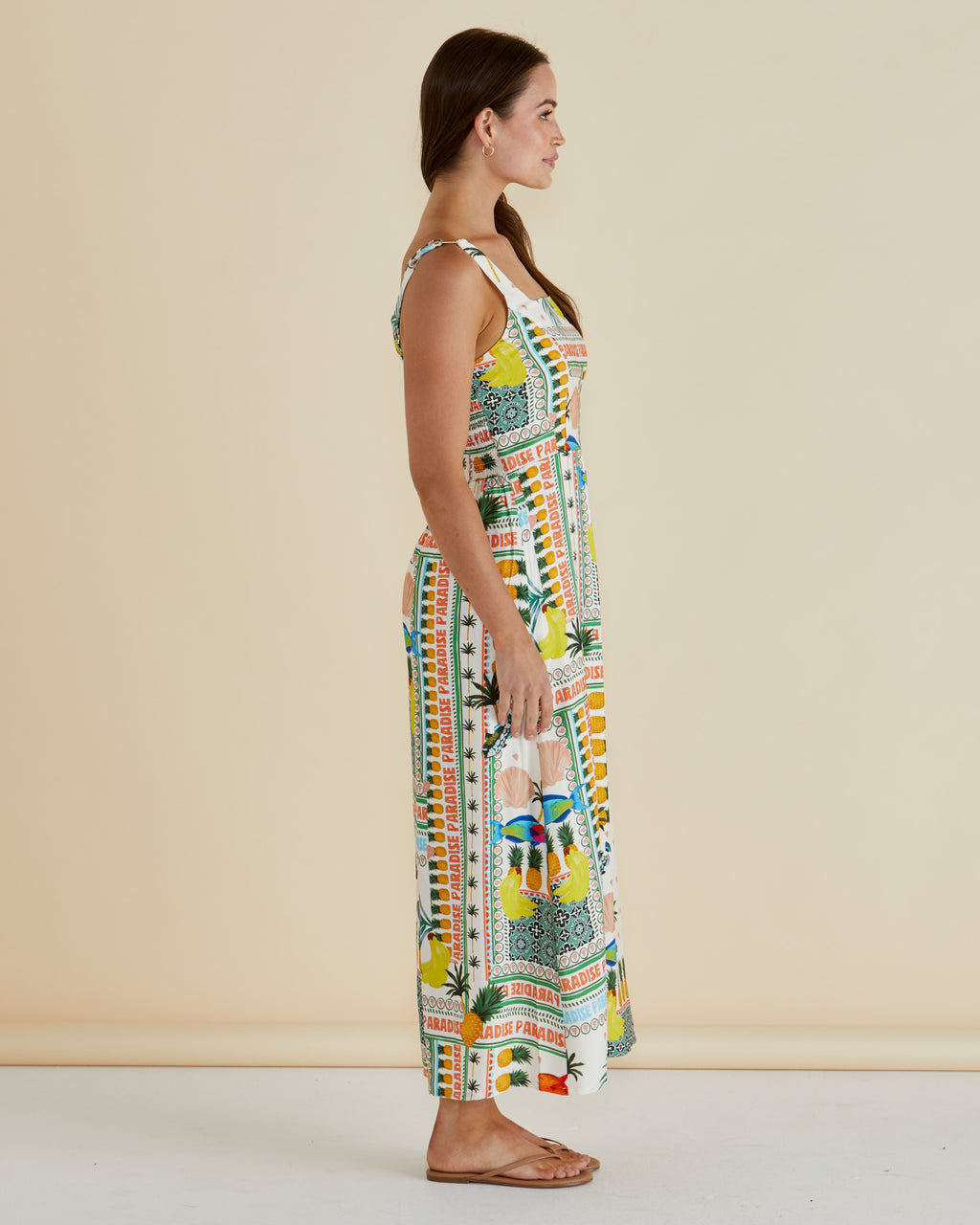 Woman wearing a colorful patterned dress against a beige background Tegan Midi Dress Paradise Print