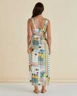 Woman wearing a colorful tropical print dress with a beige background Tegan Midi Dress Paradise Print