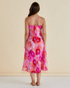 Woman wearing a colorful floral dress against a beige background Harriet Dress Floral Pink