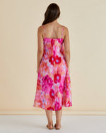Woman wearing a colorful floral dress against a beige background Harriet Dress Floral Pink