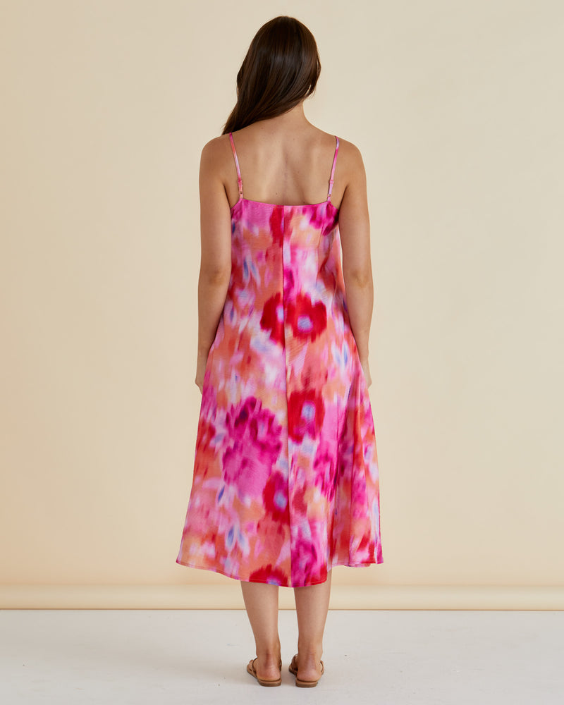 Woman wearing a colorful floral dress against a beige background Harriet Dress Floral Pink
