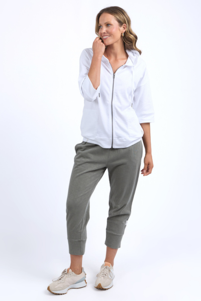 Woman wearing a white shirt and gray jogger pants on a white background
Beachy Zip Hoodie White