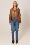 Woman wearing a patterned blouse and blue jeans on a beige background
Bohemian Top Nouveau Floral Green