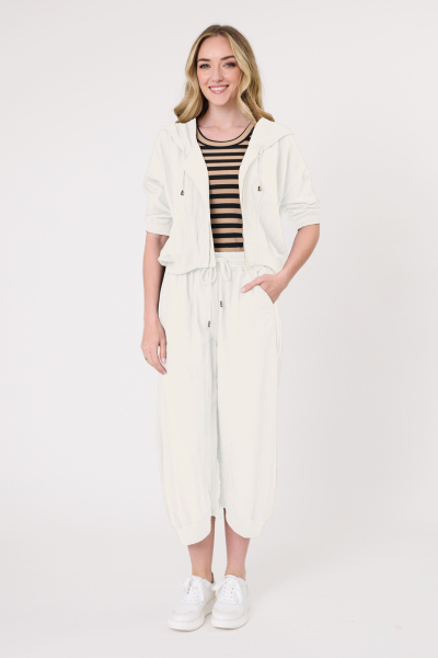 Woman wearing a white outfit with a black and white striped top on a white background
Bria Jacket Antique White