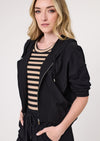 Woman wearing a black jacket over a striped dress on a white background
Bria Jacket Black