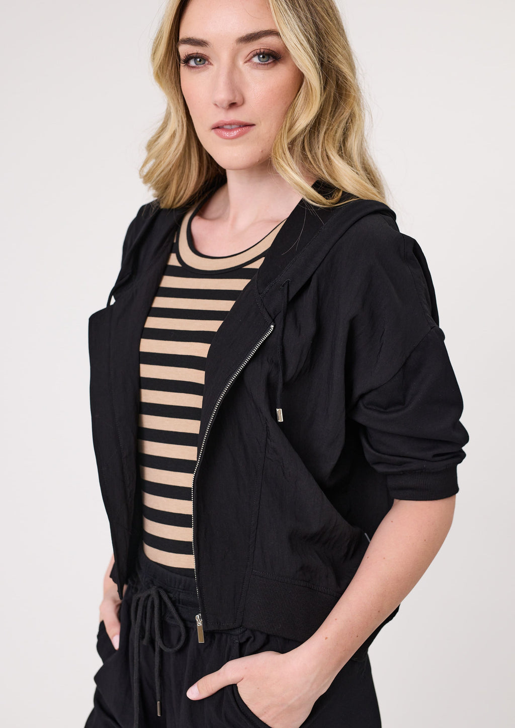 Woman wearing a black jacket over a striped dress on a white background
Bria Jacket Black