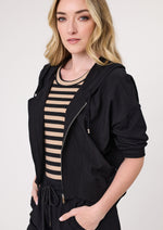 Woman wearing a black jacket over a striped dress on a white background
Bria Jacket Black