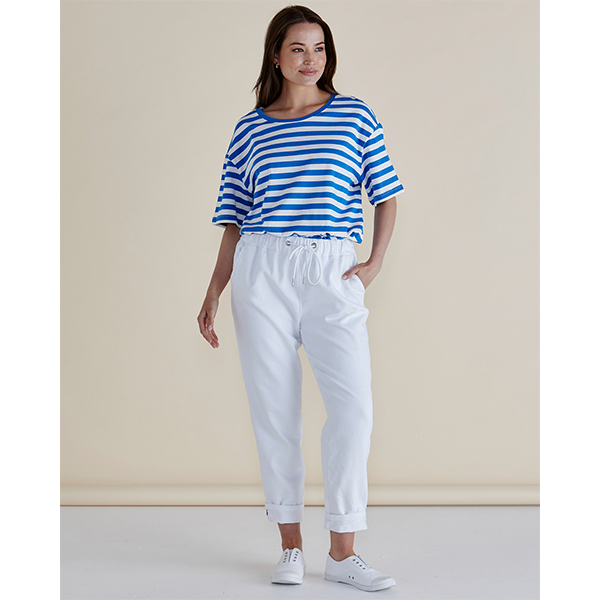 Woman wearing a blue and white striped shirt and white pants against a beige background
Brooks Jean Snow White