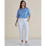 Woman wearing a blue and white striped shirt and white pants against a beige background
Brooks Jean Snow White
