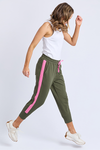 Woman wearing green jogger pants with pink stripes and a white top on a light gray background
Brunch Pants Clover Green