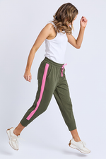 Woman wearing green jogger pants with pink stripes and a white top on a light gray background
Brunch Pants Clover Green