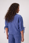Woman wearing a blue outfit with ruffled sleeves on a white background Venice Linen Jacket Denim