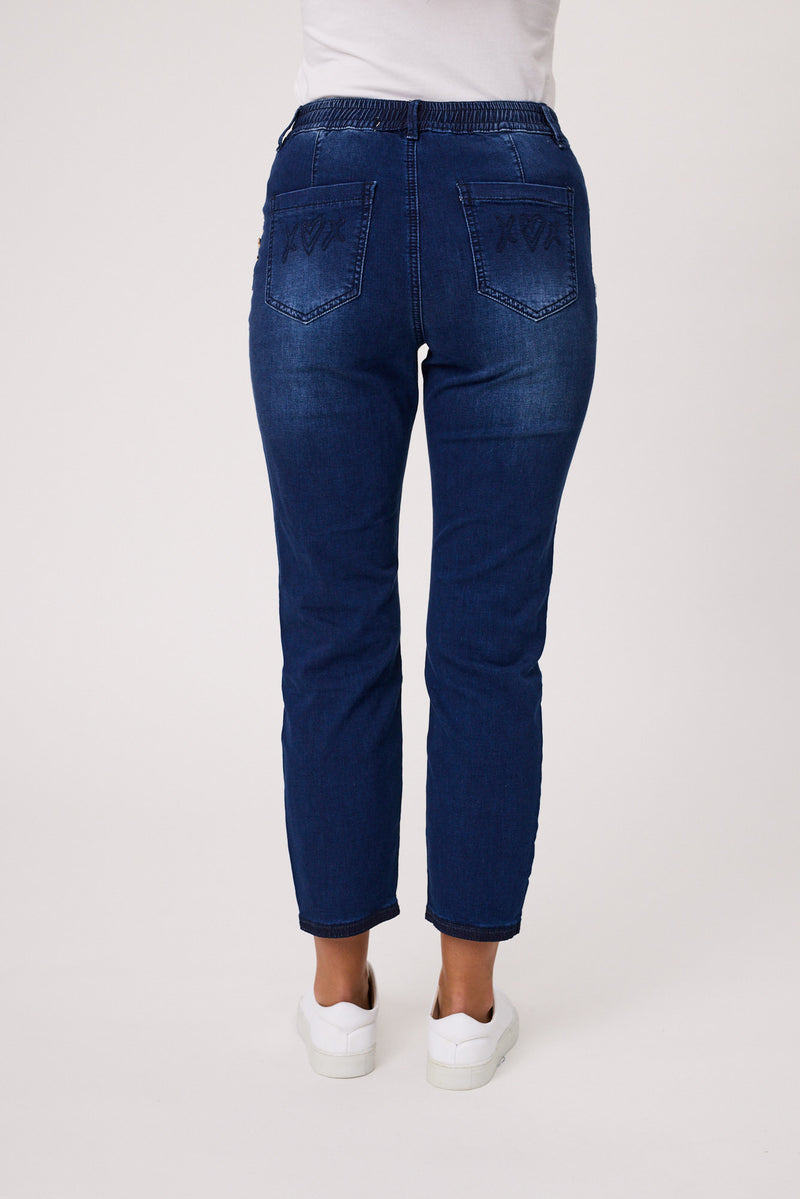 Blue jeans worn by a person on a white background